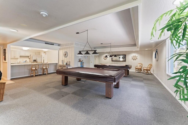 rec room with a raised ceiling and pool table