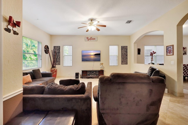 tiled living room featuring ceiling fan