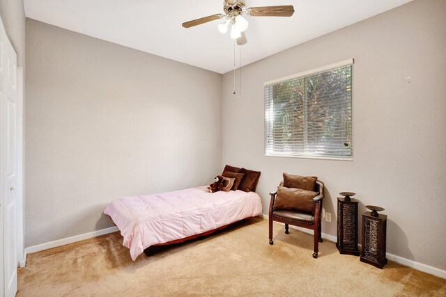 bedroom with ceiling fan and light colored carpet