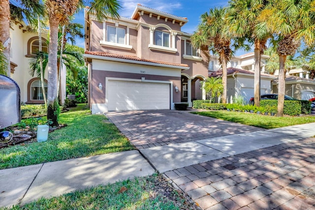 mediterranean / spanish-style house featuring a front lawn and a garage