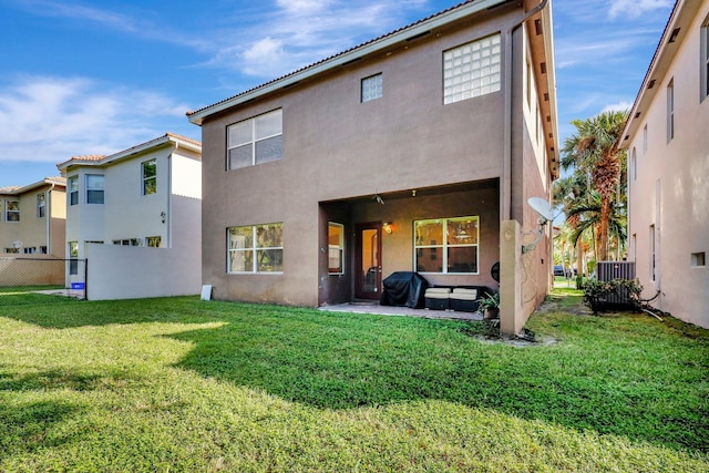 rear view of house featuring a lawn