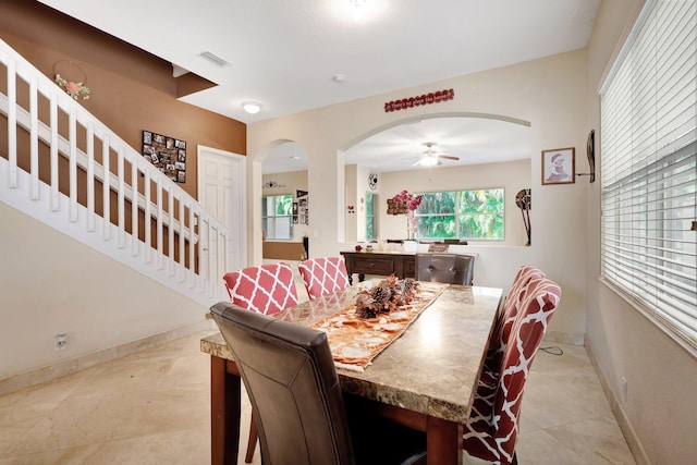 tiled dining area with ceiling fan