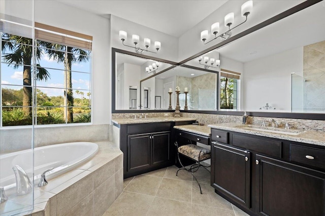 bathroom with tile patterned floors, separate shower and tub, and vanity