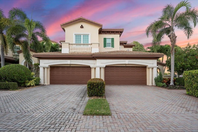 mediterranean / spanish home featuring a garage