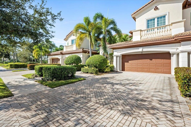 view of front of home featuring a balcony and a garage