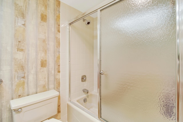 bathroom with enclosed tub / shower combo and toilet