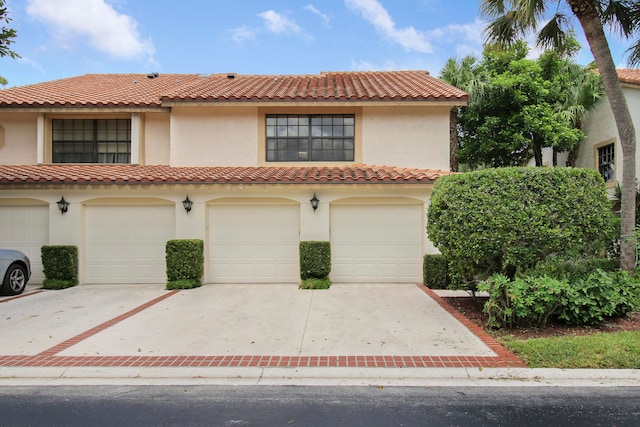 mediterranean / spanish home featuring a garage