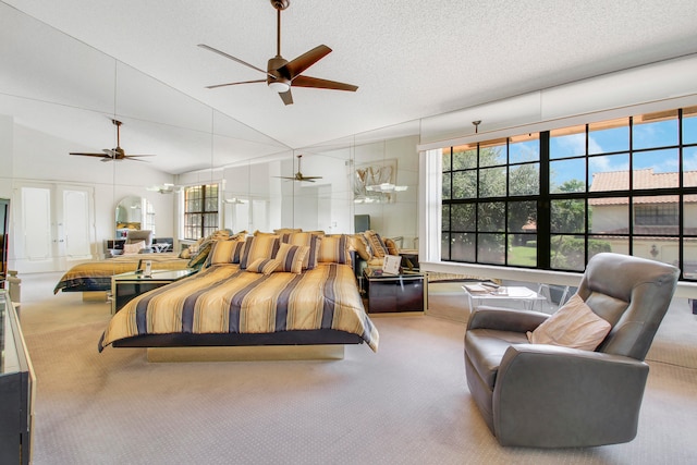 bedroom featuring a textured ceiling, french doors, carpet floors, and lofted ceiling