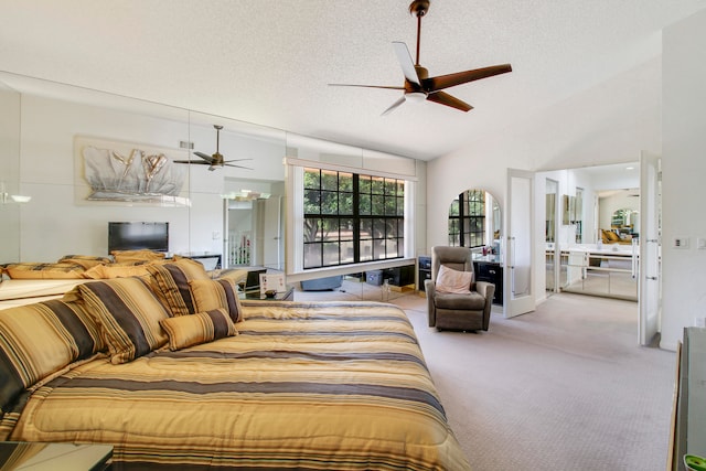 bedroom with a textured ceiling, light colored carpet, vaulted ceiling, and ceiling fan