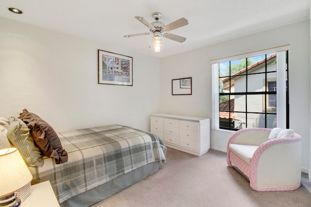 bedroom with light colored carpet and ceiling fan