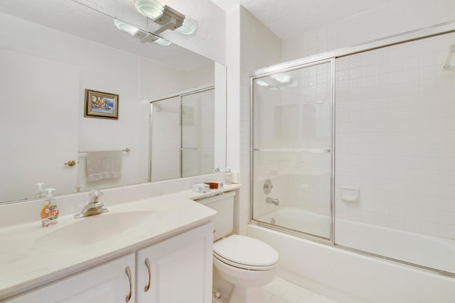 full bathroom with tile patterned flooring, vanity, toilet, and enclosed tub / shower combo