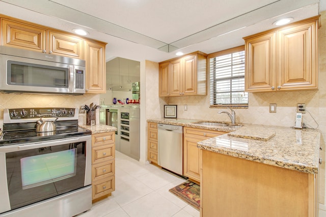 kitchen with light brown cabinets, sink, and appliances with stainless steel finishes