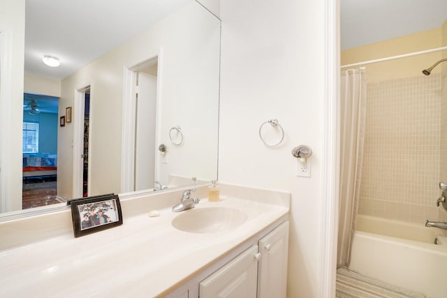 bathroom with vanity, ceiling fan, and shower / bath combo with shower curtain