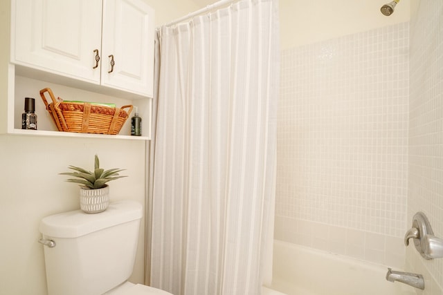 bathroom with shower / bathtub combination with curtain and toilet