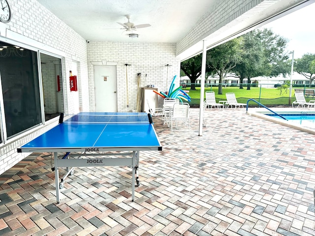 view of patio / terrace featuring ceiling fan and a community pool