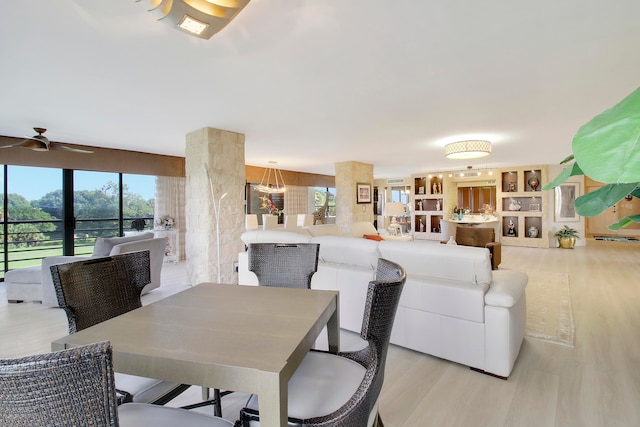 dining area featuring ceiling fan and light wood-type flooring