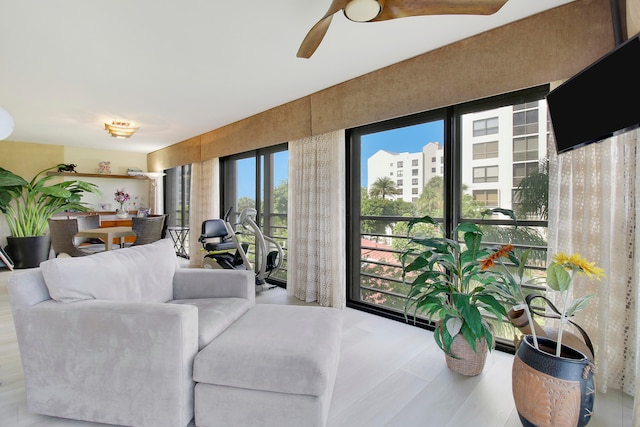 living room featuring ceiling fan and light hardwood / wood-style flooring