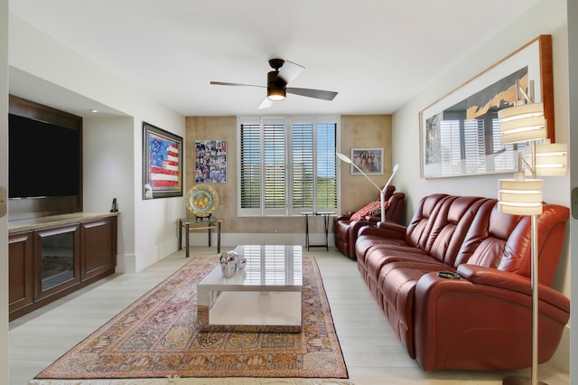 living room featuring ceiling fan, light wood-type flooring, and plenty of natural light