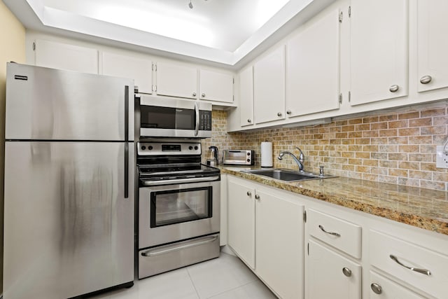 kitchen featuring white cabinets, light stone countertops, sink, and appliances with stainless steel finishes