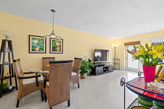 dining area with light tile patterned flooring and a textured ceiling