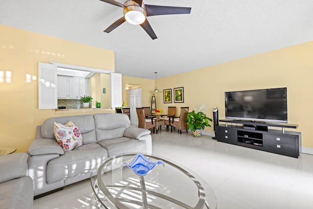 living room with a textured ceiling and ceiling fan