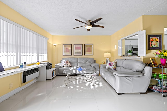 tiled living room featuring ceiling fan and a textured ceiling