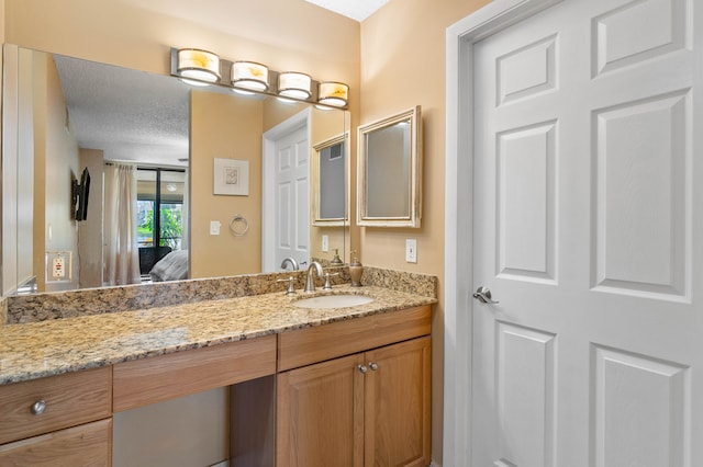 bathroom featuring vanity and a textured ceiling