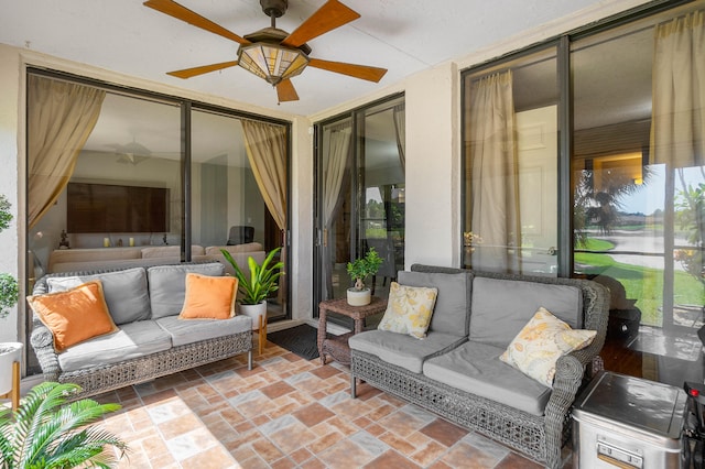 sunroom / solarium featuring ceiling fan