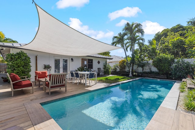 view of pool featuring french doors and an outdoor living space