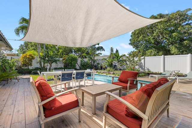 deck featuring a fenced in pool