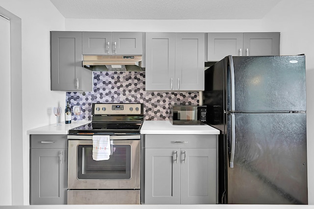 kitchen with tasteful backsplash, gray cabinets, and black appliances