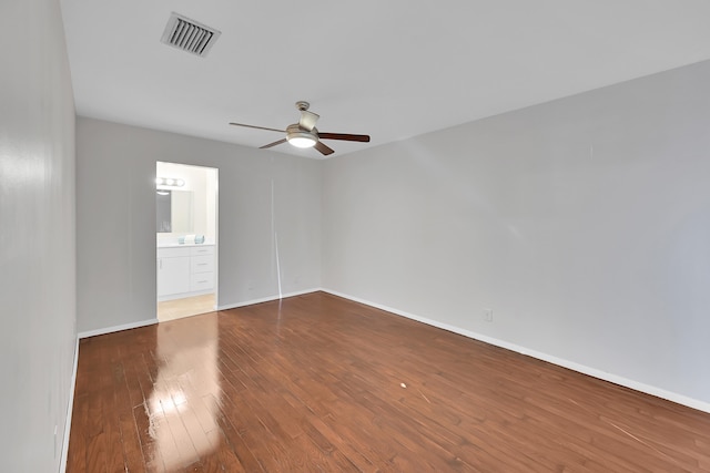 empty room with hardwood / wood-style floors and ceiling fan