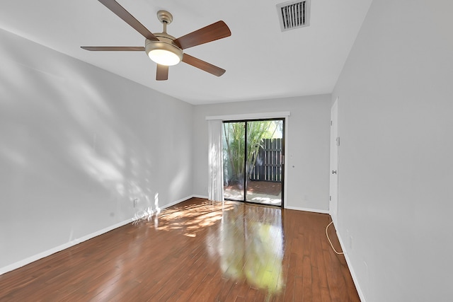 unfurnished room featuring ceiling fan and dark hardwood / wood-style floors