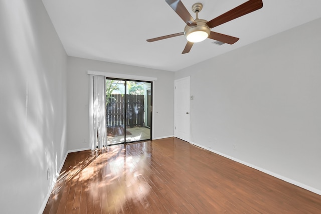 unfurnished room with ceiling fan and dark hardwood / wood-style flooring