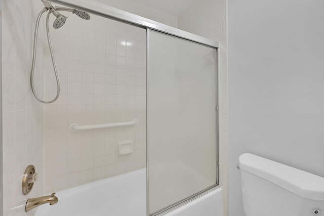 bathroom with toilet and enclosed tub / shower combo