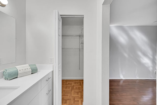 bathroom with vanity and wood-type flooring