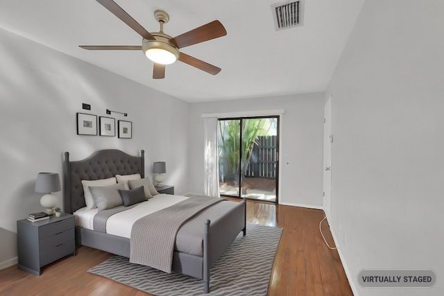 bedroom with ceiling fan, access to exterior, and wood-type flooring