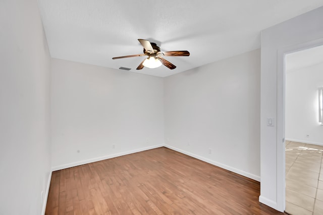 unfurnished room featuring ceiling fan and wood-type flooring