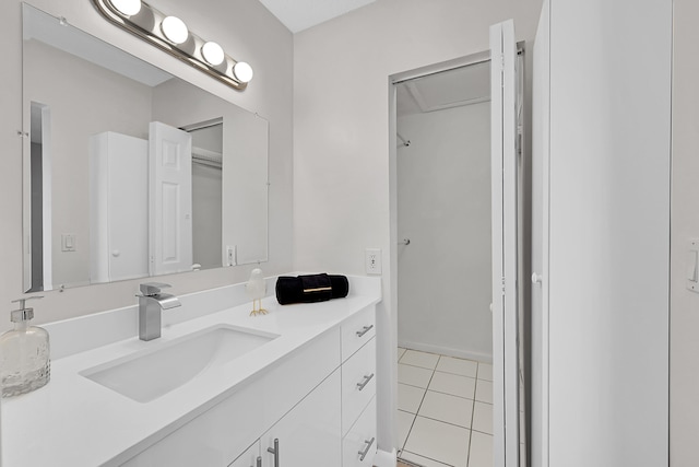 bathroom featuring tile patterned flooring and vanity