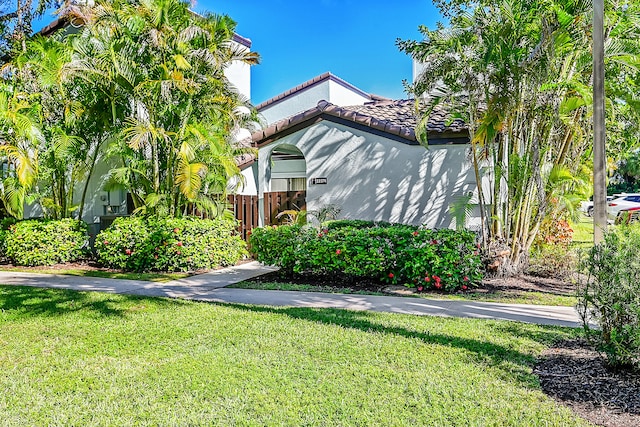 view of home's exterior with a lawn