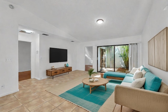 living room with light tile patterned floors and vaulted ceiling