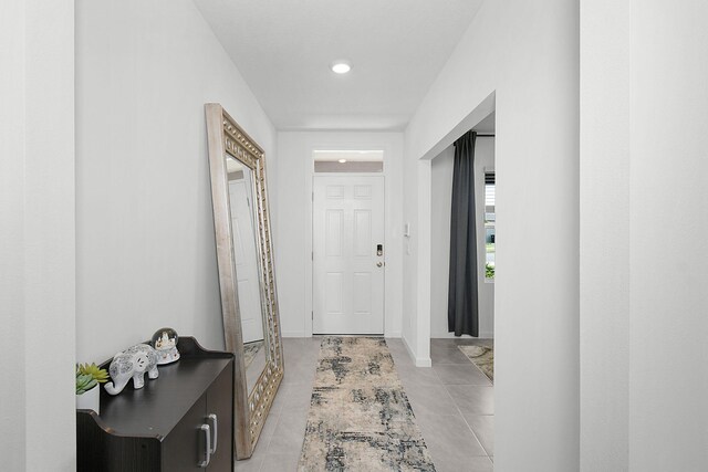 hallway featuring light tile patterned floors