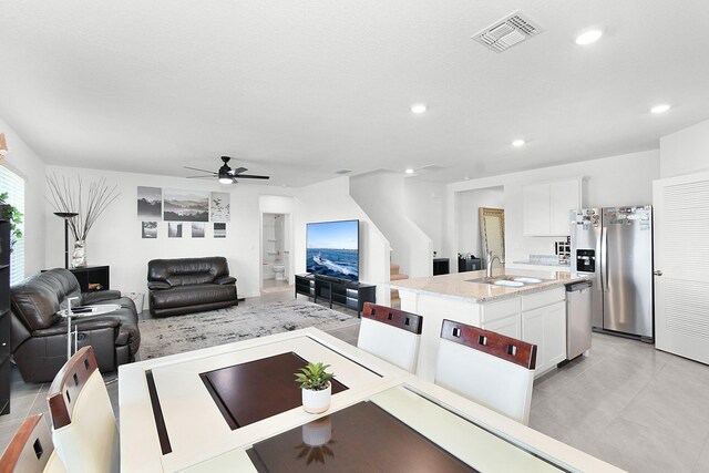 living room with ceiling fan and sink