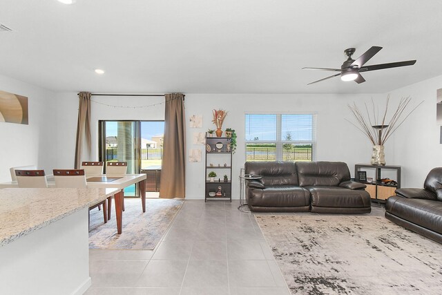 tiled living room featuring ceiling fan