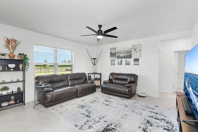 living room with light tile patterned floors and ceiling fan