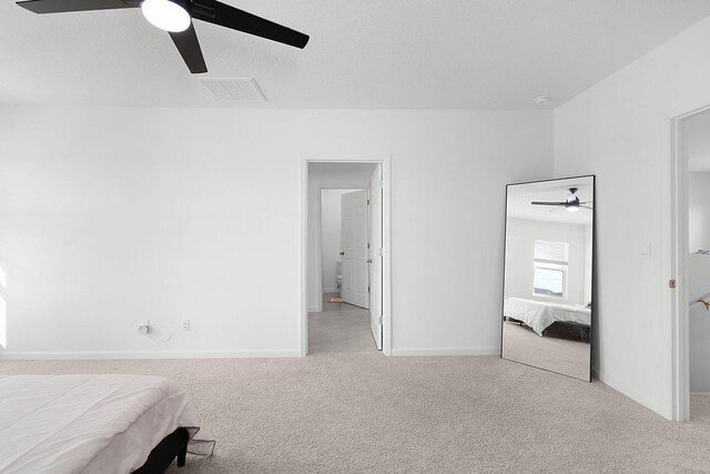 unfurnished bedroom featuring light colored carpet and ceiling fan