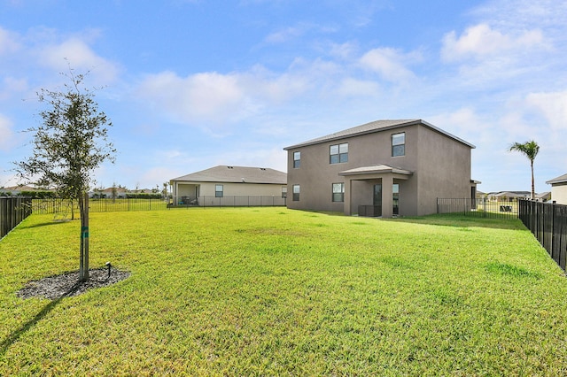 back of house with a lawn