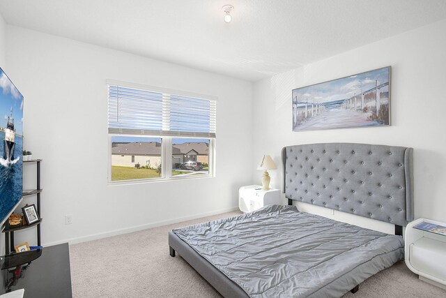 bedroom with light colored carpet