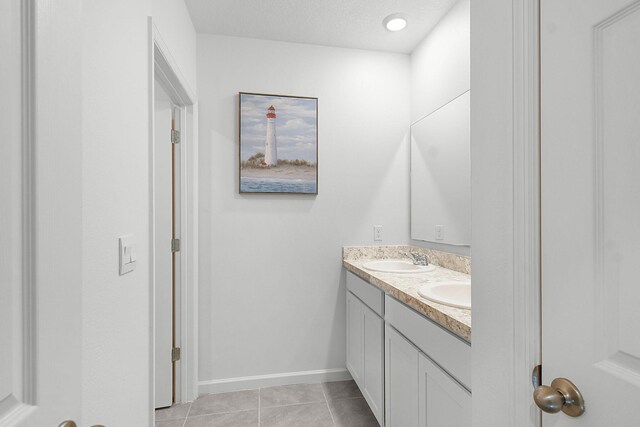 bathroom with tile patterned flooring and vanity