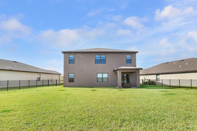 rear view of house with a yard